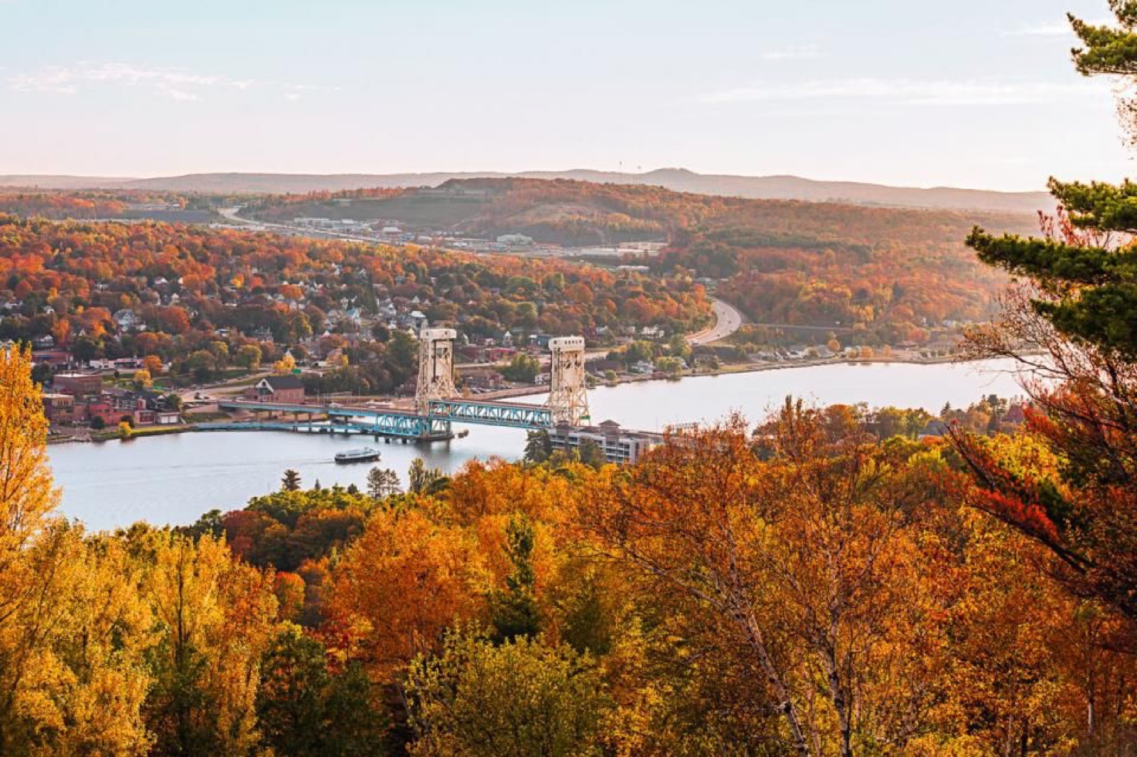 The Portage Lake Lift Bridge framed by fall foliage