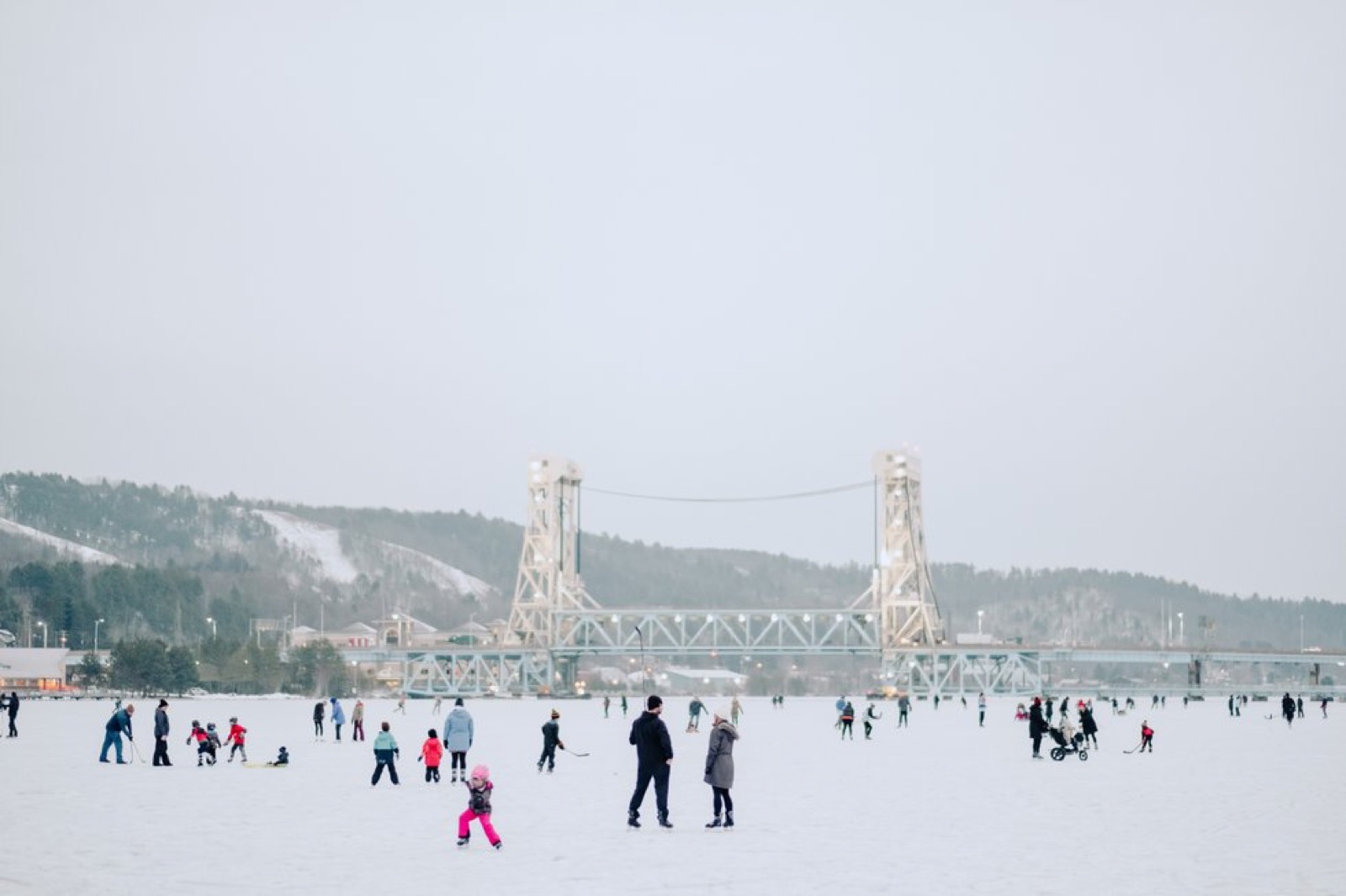 People out on frozen Portage Lake in front of the lift bridge